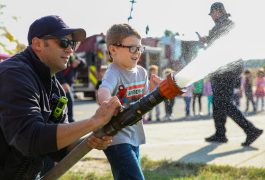 Firefighter operates hose