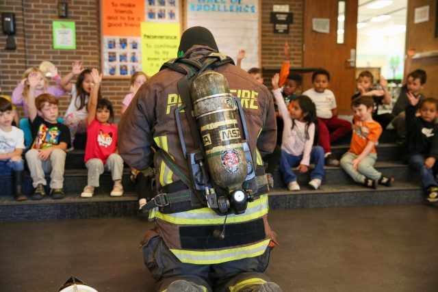 firefighter talking to students