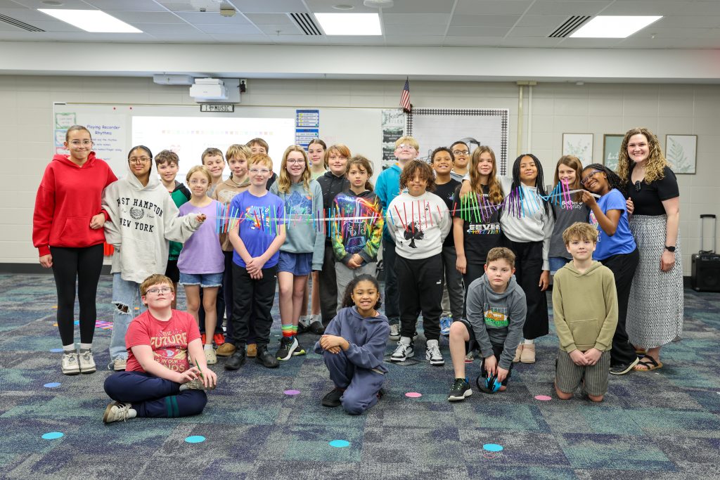Students posing in a classroom for a group picture.